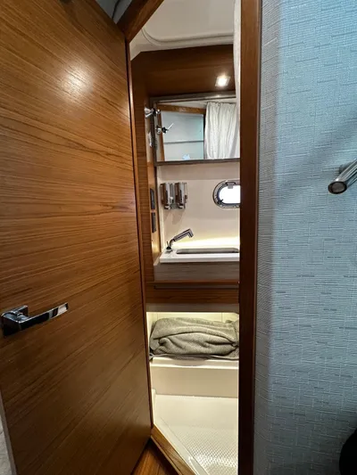  Yacht Photos Pics 2023 Tiara Yachts 34 LS bathroom interior with wooden door and modern fixtures.