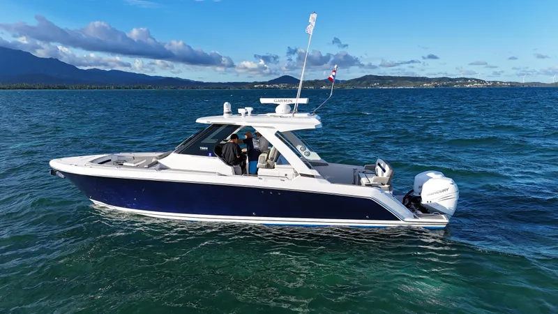  Yacht Photos Pics 2023 Tiara Yachts 34 LS cruising on open water under clear skies.