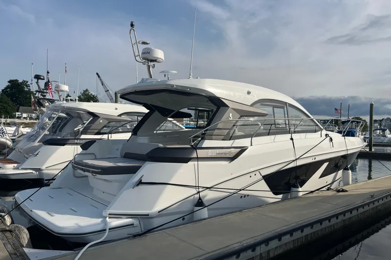 Yacht Photos Pics 2026 Beneteau Gran Turismo 41 yacht docked at marina under cloudy sky.