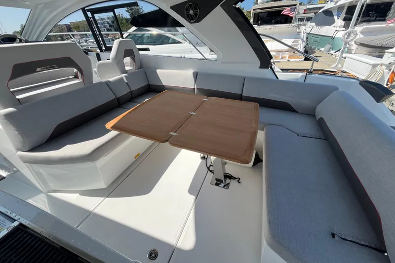  Yacht Photos Pics Luxurious seating area on 2026 Beneteau Gran Turismo 41 yacht with wooden table.