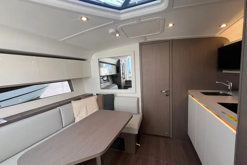  Yacht Photos Pics Luxurious interior of 2026 Beneteau Gran Turismo 41 yacht with modern kitchen and seating area.