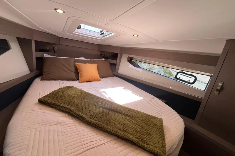  Yacht Photos Pics Luxurious cabin interior of 2026 Beneteau Gran Turismo 41 yacht with cozy bedding.