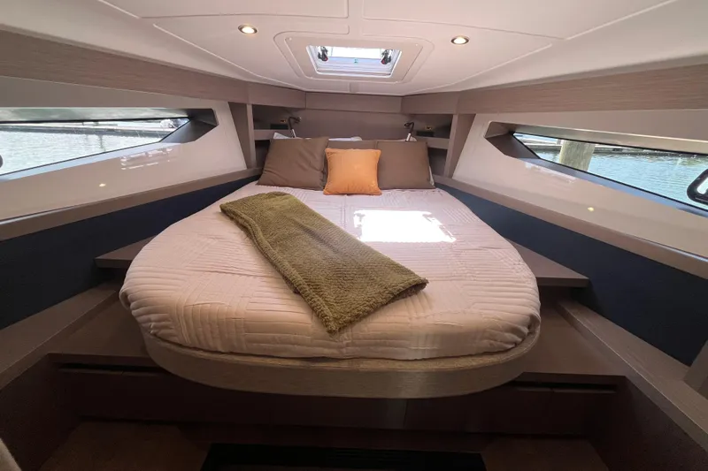  Yacht Photos Pics Luxurious cabin interior of 2026 Beneteau Gran Turismo 41 yacht with cozy bedding.