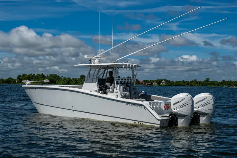  Yacht Photos Pics 2022 Freeman 34VH boat on water with dual Mercury engines, under a partly cloudy sky.
