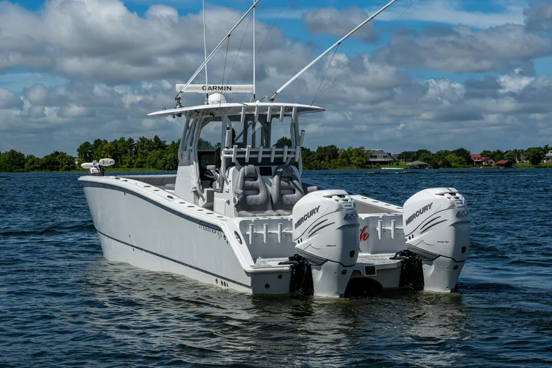  Yacht Photos Pics Freeman 34VH 2022 boat with twin Mercury engines on a calm lake.