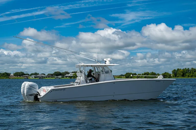  Yacht Photos Pics 2022 Freeman 34VH boat cruising on a sunny day with blue skies and clouds.