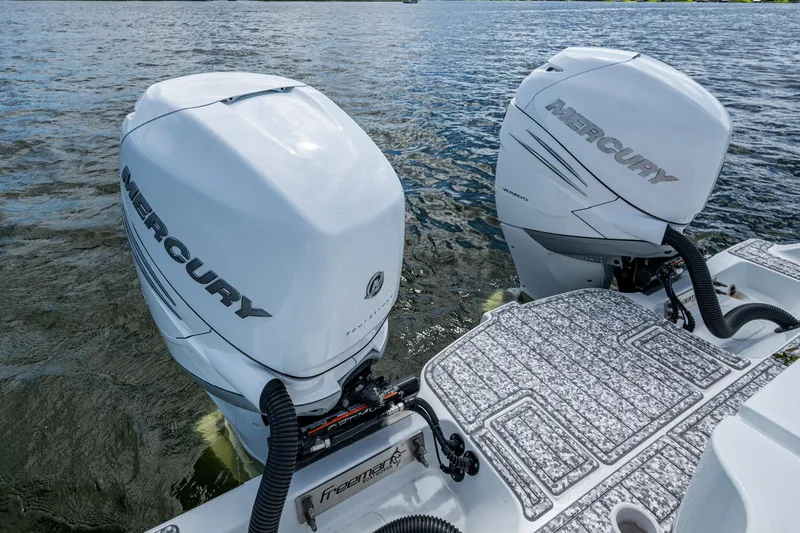  Yacht Photos Pics Twin Mercury outboard engines on a 2022 Freeman 34VH boat, cruising on water.