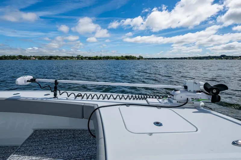  Yacht Photos Pics 2022 Freeman 34VH boat with trolling motor on calm lake under blue sky.