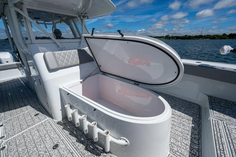  Yacht Photos Pics 2022 Freeman 34VH boat with open storage compartment on deck, under clear blue sky.