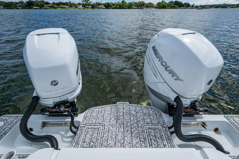  Yacht Photos Pics Twin Mercury outboard engines on a 2022 Freeman 34VH boat, cruising on a lake.