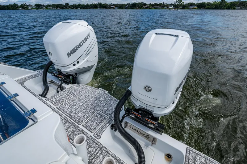  Yacht Photos Pics 2022 Freeman 34VH boat with dual Mercury outboard engines on a lake.