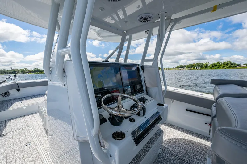  Yacht Photos Pics 2022 Freeman 34VH boat interior with modern navigation system and steering wheel on a sunny day.
