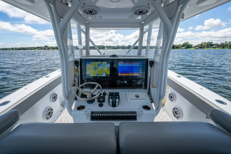  Yacht Photos Pics 2022 Freeman 34VH boat cockpit with navigation screens, steering wheel, and water view.