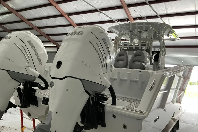  Yacht Photos Pics 2022 Freeman 34VH boat with twin Mercury 400 engines in a covered storage area.