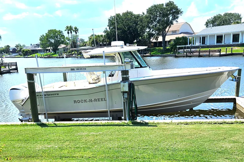  Yacht Photos Pics 2022 Grady-White Canyon 306 boat docked by a scenic waterfront.