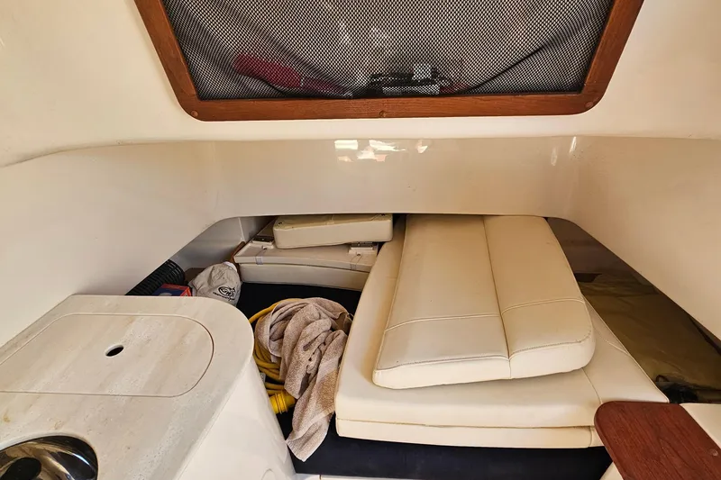  Yacht Photos Pics 2022 Grady-White Canyon 306 cabin interior with cushions and storage area.