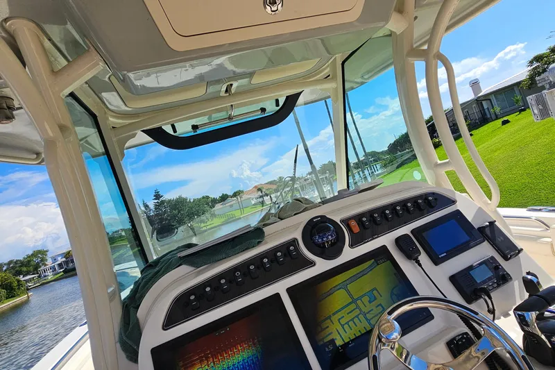  Yacht Photos Pics Interior view of 2022 Grady-White Canyon 306 boat cockpit with navigation equipment.