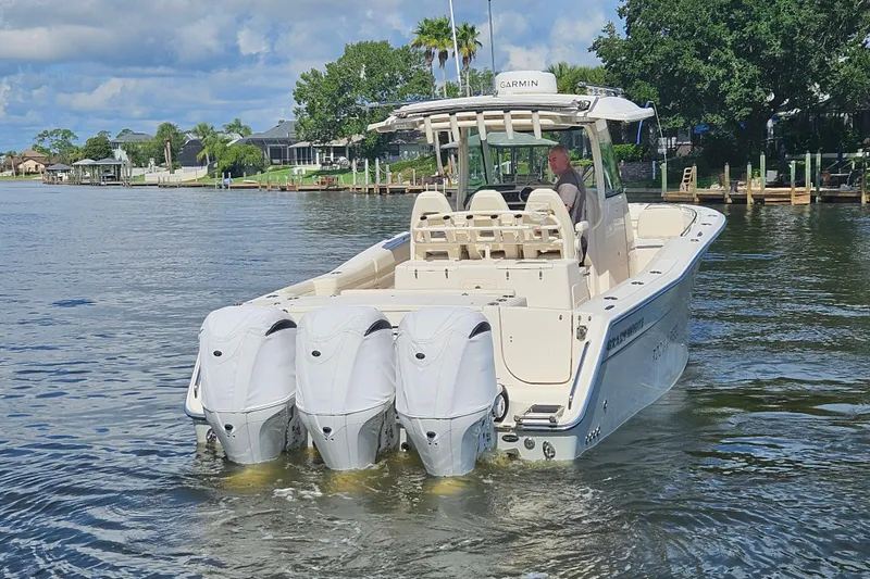  Yacht Photos Pics 2022 Grady-White Canyon 306 boat with triple engines on a scenic waterway.