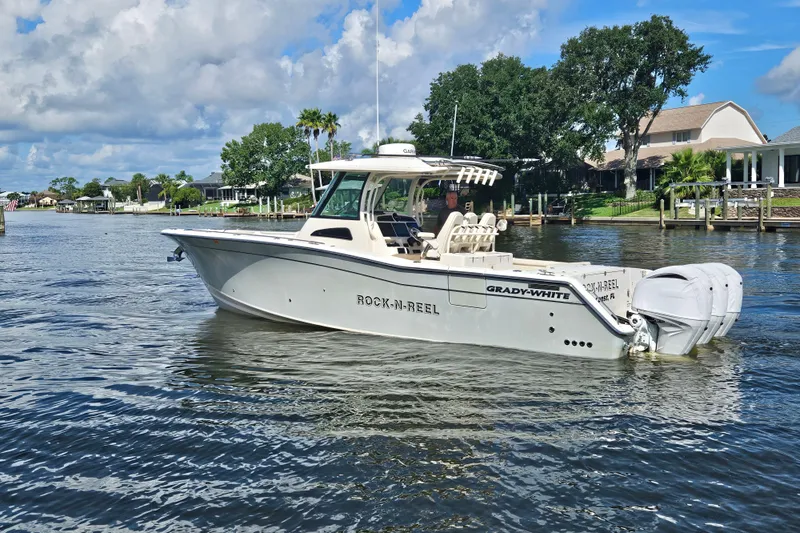  Yacht Photos Pics 2022 Grady-White Canyon 306 boat on a scenic waterway with lush greenery.