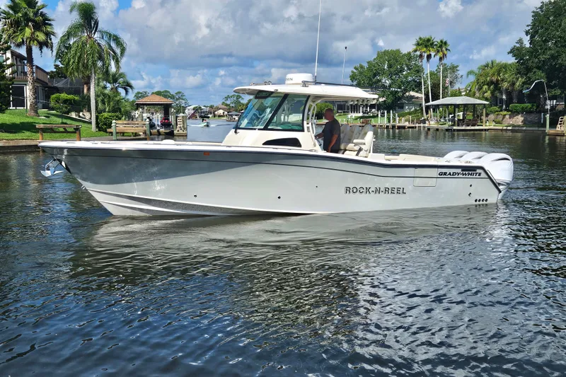  Yacht Photos Pics 2022 Grady-White Canyon 306 boat cruising on a scenic waterway.