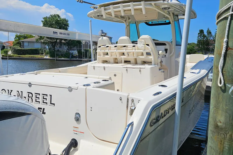  Yacht Photos Pics 2022 Grady-White Canyon 306 boat docked, featuring spacious seating and sleek design.