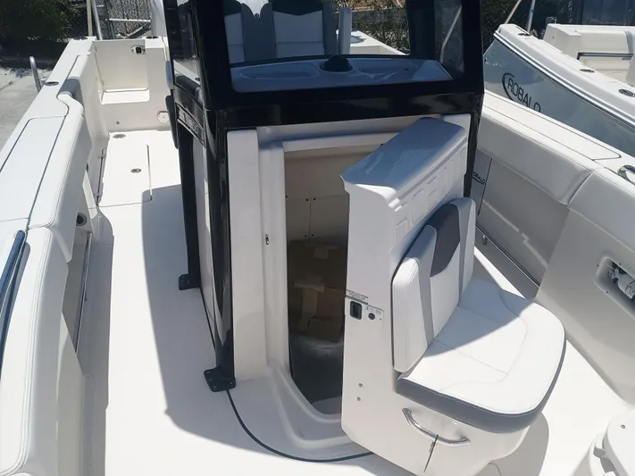  Yacht Photos Pics 2024 Robalo R250 Center Console boat interior with seating and storage area.