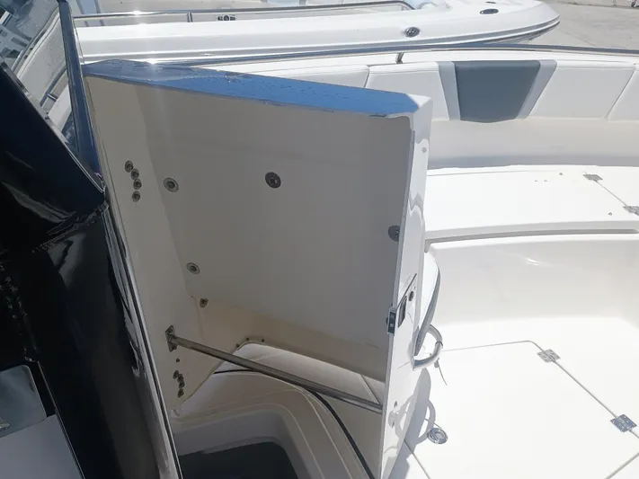  Yacht Photos Pics 2024 Robalo R250 Center Console boat interior storage compartment open.