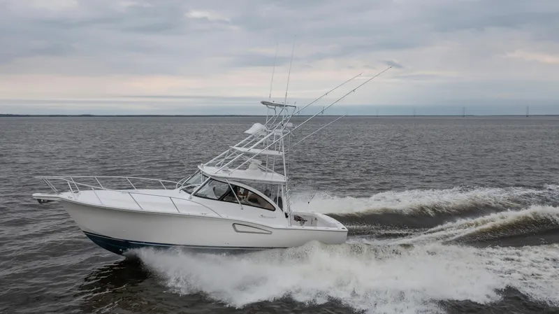  Yacht Photos Pics 2025 Albemarle 36 Express boat cruising on open water under cloudy skies.