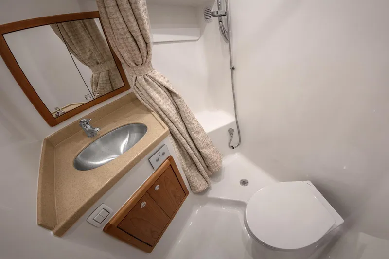  Yacht Photos Pics 2025 Albemarle 36 Express bathroom with sink, shower, and toilet.