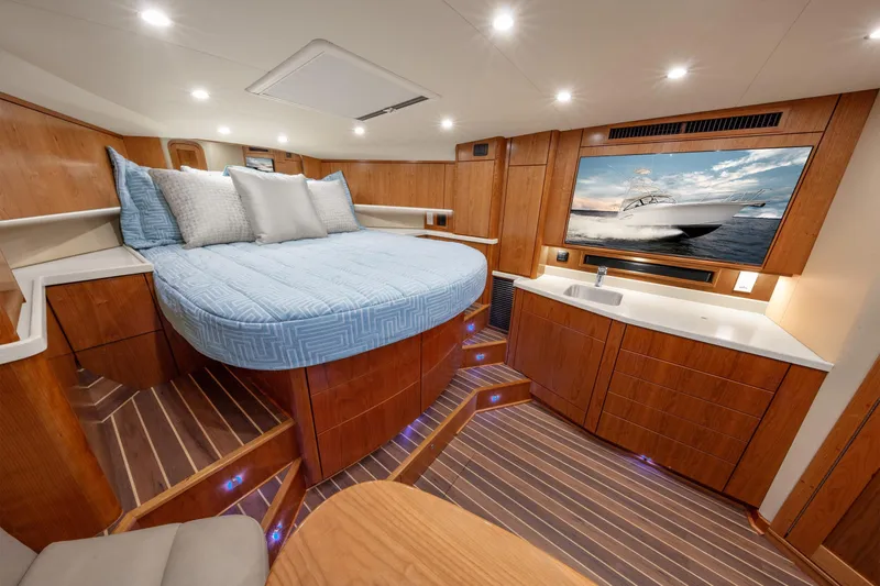  Yacht Photos Pics 2025 Albemarle 36 Express cabin with bed, TV, and wooden interior.