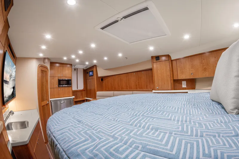  Yacht Photos Pics Luxurious interior of 2025 Albemarle 36 Express yacht with modern amenities and cozy bedding.