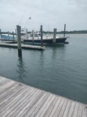 Contessa Yacht Photos Pics 2001 Grand Banks 49 Eastbay SX docked at a marina on a cloudy day.