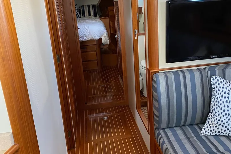 Contessa Yacht Photos Pics Interior of 2001 Grand Banks 49 Eastbay SX with wood flooring and striped seating.