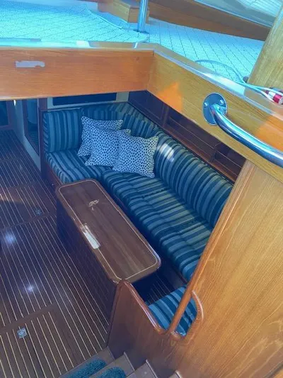 Contessa Yacht Photos Pics Interior of 2001 Grand Banks 49 Eastbay SX with striped seating and wooden finishes.