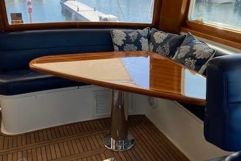 Contessa Yacht Photos Pics Luxurious 2001 Grand Banks 49 Eastbay SX yacht interior with elegant wooden table and plush seating.
