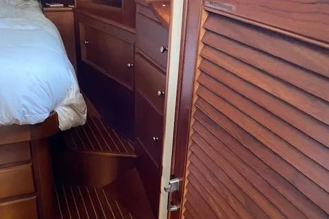 Contessa Yacht Photos Pics Interior of 2001 Grand Banks 49 Eastbay SX yacht with wooden cabinetry and bed.