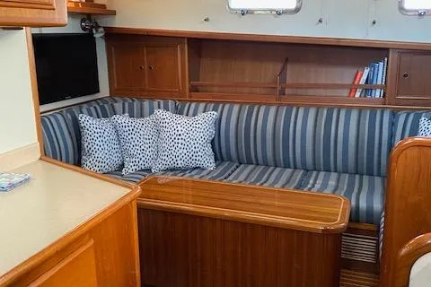 Contessa Yacht Photos Pics Interior of 2001 Grand Banks 49 Eastbay SX with striped seating and wooden cabinetry.