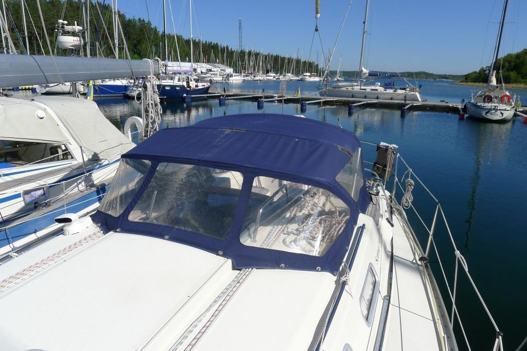 Sailboats docked at a marina, featuring a Scanner 391 from 2006 with a blue canopy.