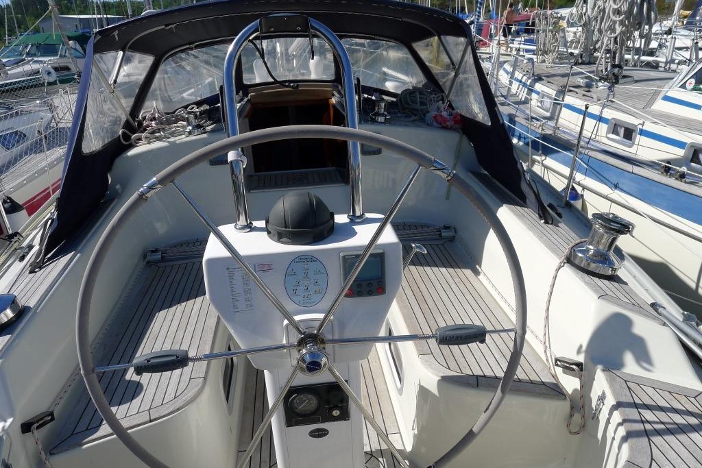Sailboat cockpit with steering wheel, navigation instruments, and seating, Scanner 391, 2006 model.