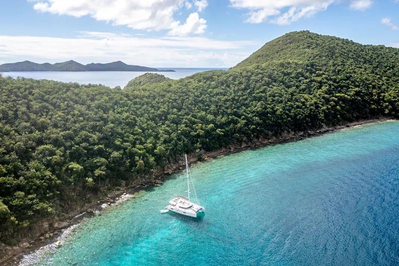 Yacht Photos Pics 2019 Fountaine Pajot Ipanema 58 catamaran anchored in a serene tropical bay.