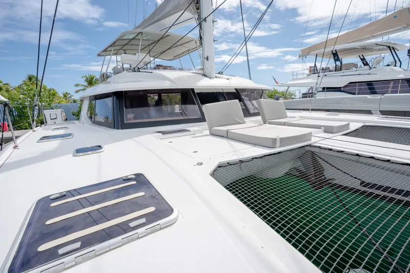  Yacht Photos Pics 2019 Fountaine Pajot Ipanema 58 catamaran with spacious deck and seating under clear skies.