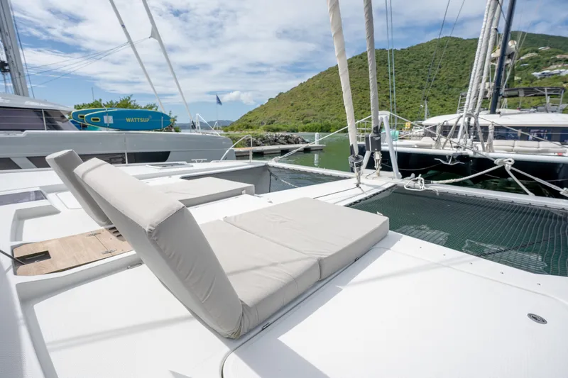  Yacht Photos Pics Luxurious 2019 Fountaine Pajot Ipanema 58 catamaran with sunbathing area, docked in scenic marina.