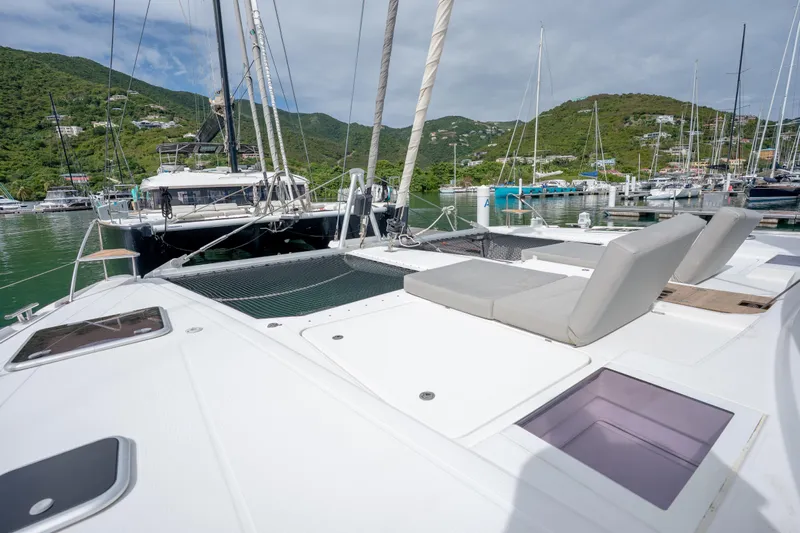  Yacht Photos Pics 2019 Fountaine Pajot Ipanema 58 catamaran docked in scenic marina with lush hills.