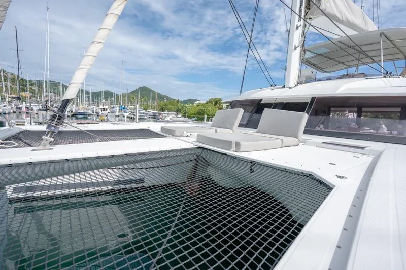  Yacht Photos Pics 2019 Fountaine Pajot Ipanema 58 catamaran with spacious deck and netting, docked in marina.