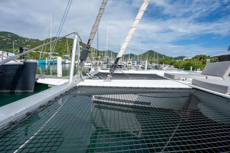  Yacht Photos Pics 2019 Fountaine Pajot Ipanema 58 catamaran docked in a scenic marina.