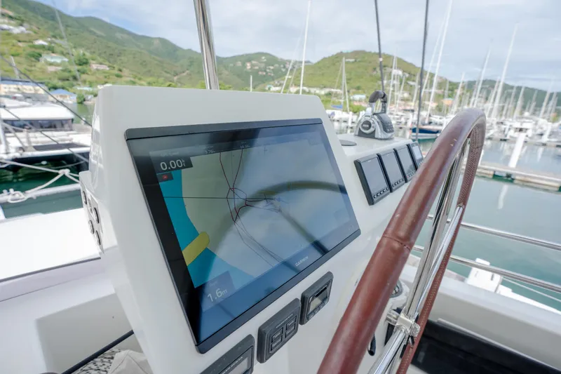  Yacht Photos Pics Helm of 2019 Fountaine Pajot Ipanema 58 catamaran with navigation display in marina.