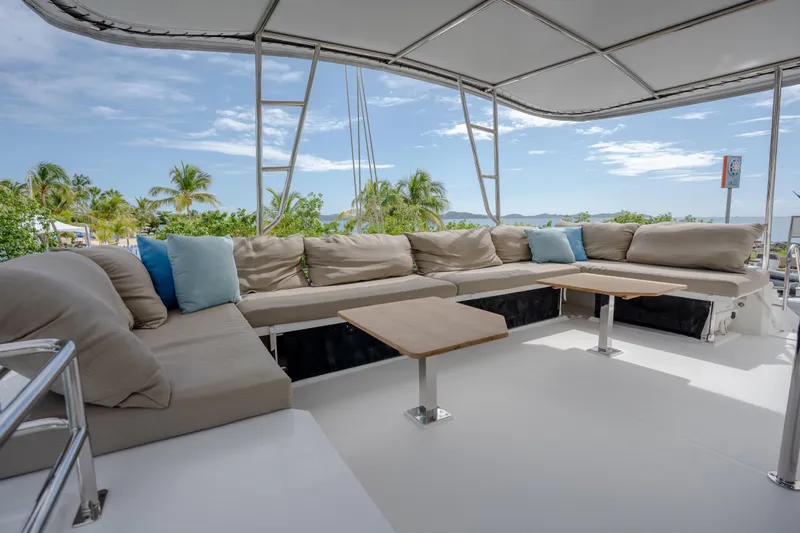  Yacht Photos Pics Spacious outdoor seating on 2019 Fountaine Pajot Ipanema 58 catamaran with tropical backdrop.