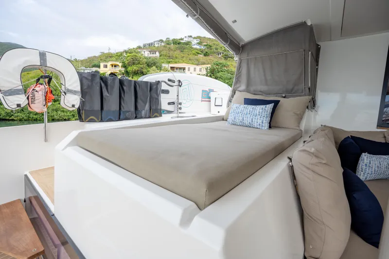 Yacht Photos Pics Luxurious outdoor seating on 2019 Fountaine Pajot Ipanema 58 yacht with scenic backdrop.