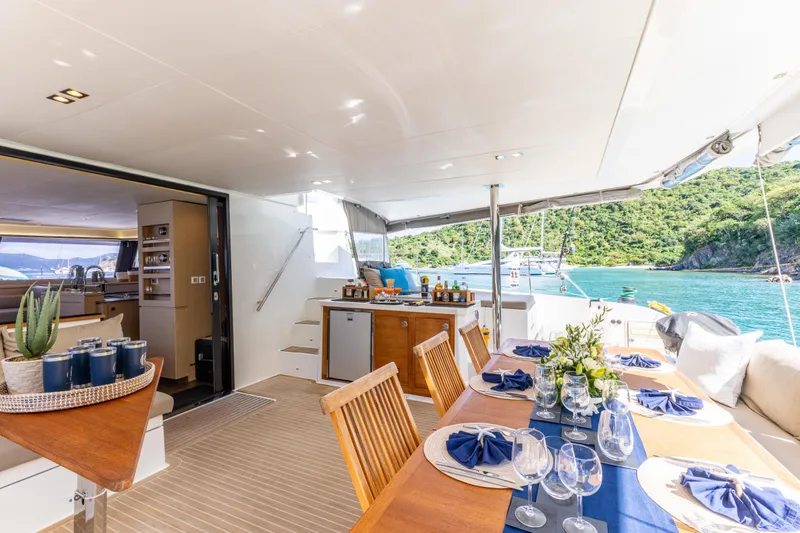  Yacht Photos Pics Luxurious 2019 Fountaine Pajot Ipanema 58 yacht with elegant outdoor dining setup.