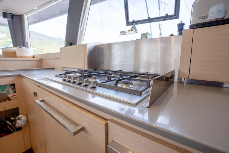  Yacht Photos Pics Modern kitchen on 2019 Fountaine Pajot Ipanema 58 yacht with stainless steel stove.